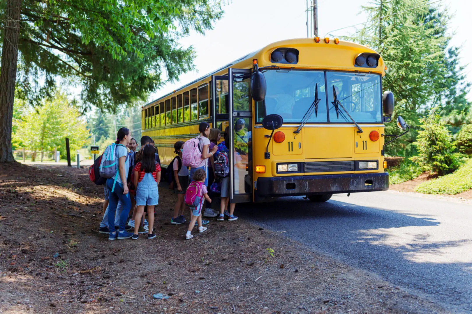 Students boarding a yellow school bus outdoors.