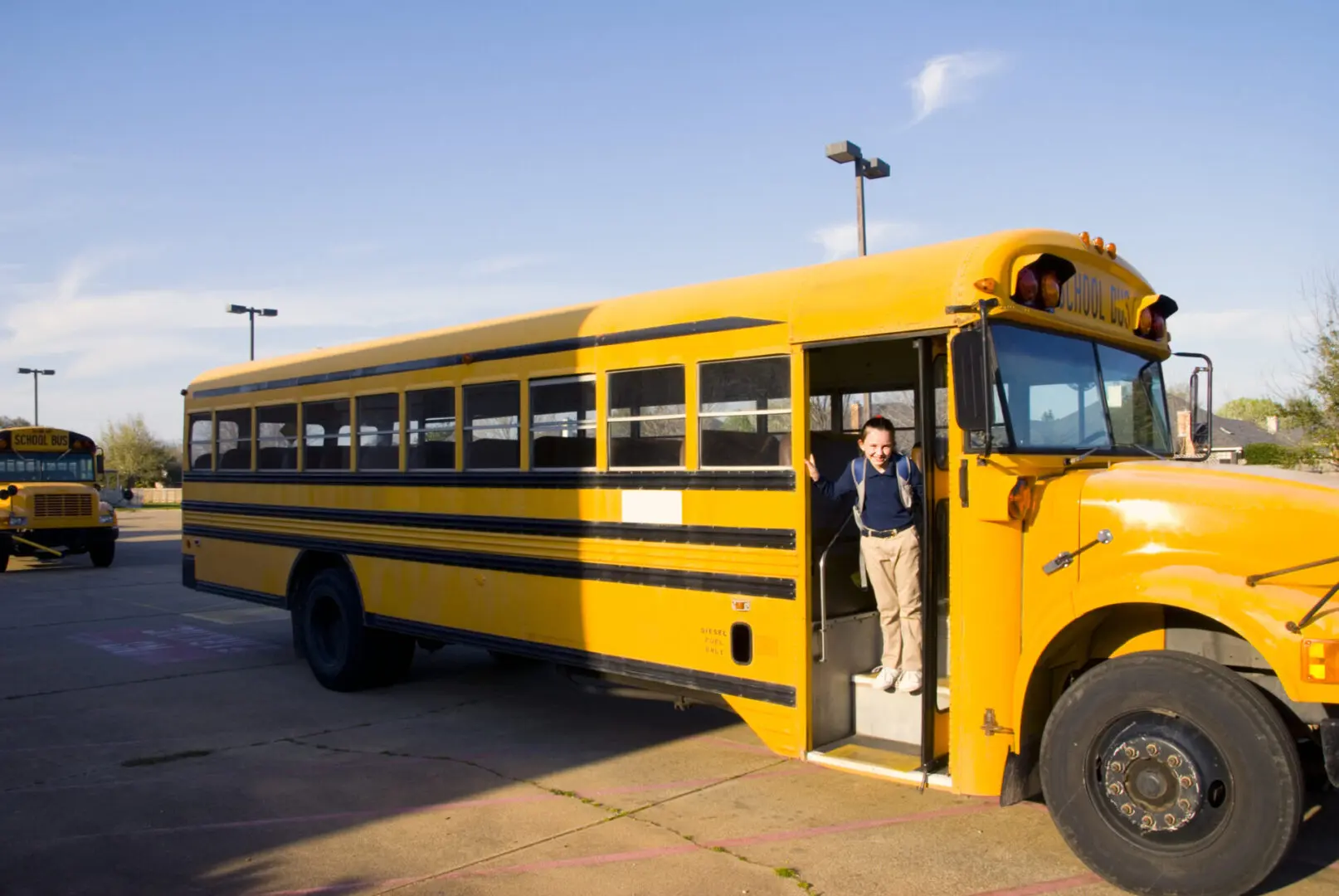 Person standing at school bus door.