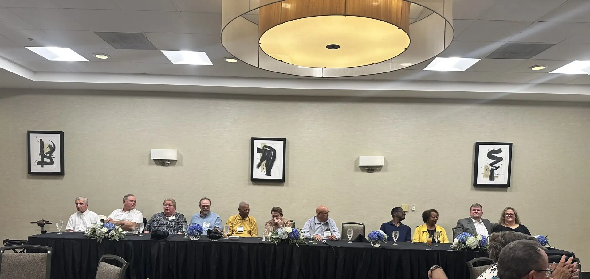 People sitting at a conference table.