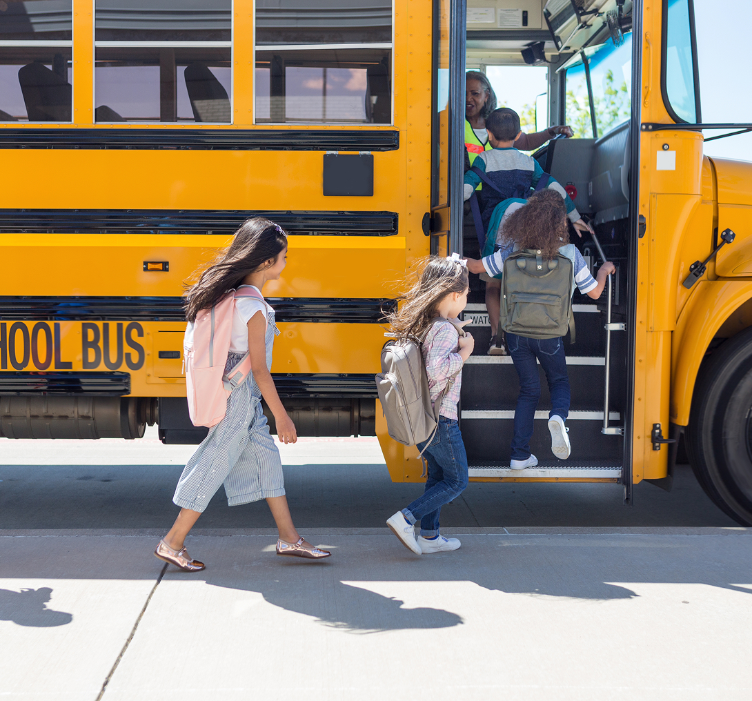 Children boarding a yellow school bus.